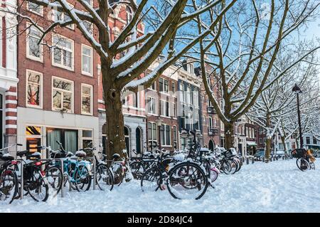 Amsterdam town square in winter with snow covered bicycles Stock Photo