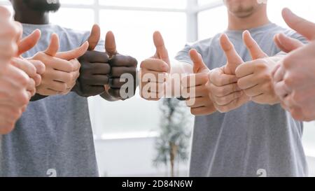 close up. group of like-minded showing thumbs up. Stock Photo