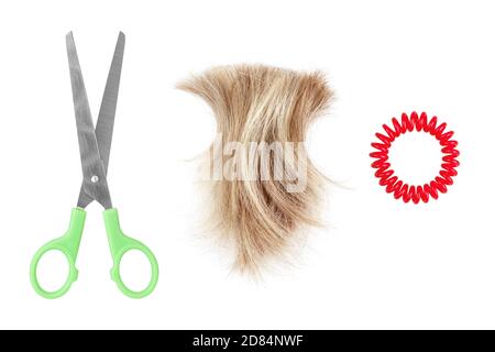 Blond hair lock, metal scissors, scrunchy white background isolated closeup, cut off blonde hair curl, steel shears, spiral hair band, hairstyle Stock Photo