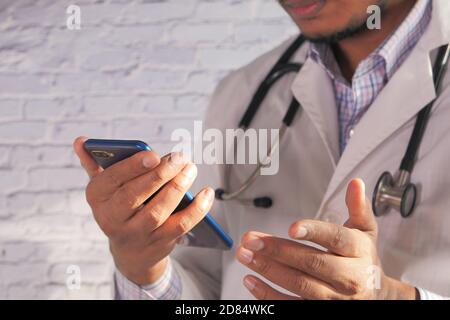 close up of doctor hand using smart phone indoor  Stock Photo