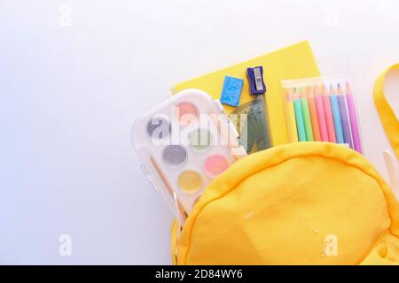 yellow backpack and school suppliers on white background  Stock Photo
