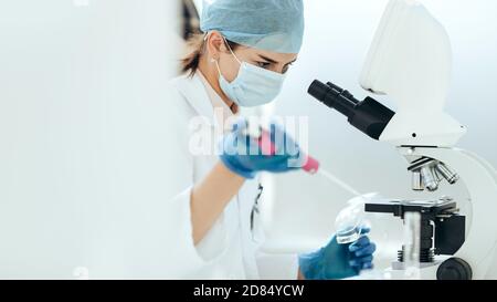 female scientist conducts research in the laboratory. Stock Photo