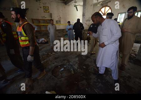 Peshawar, Pakistan. 27th Oct, 2020. Pakistani rescue workers and police officers examine the site of a bomb explosion in an Islamic seminary. A powerful bomb blast ripped through the Islamic seminary on the outskirts of the northwest Pakistani city of Peshawar on Tuesday morning, killing some students and wounding dozens others, police and a hospital spokesman said. (Photo by Hussain Ali/Pacific Press) Credit: Pacific Press Media Production Corp./Alamy Live News Stock Photo