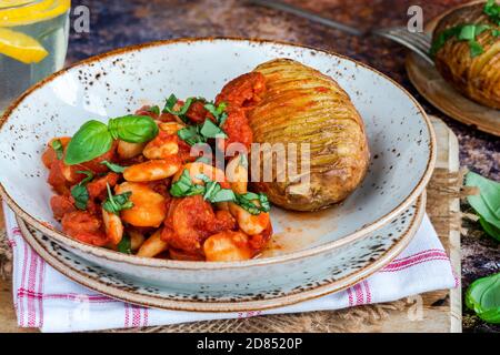 Chorizo and butterbean stew with baked jacket potato Stock Photo