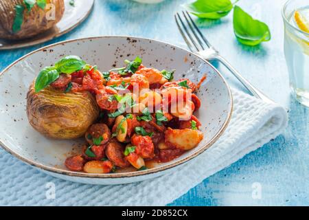 Chorizo and butterbean stew with baked jacket potato Stock Photo