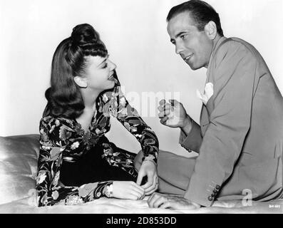 IDA LUPINO and HUMPHREY BOGART Candid Portrait taken during filming of THEY DRIVE BY NIGHT 1940 director RAOUL WALSH associate producer Mark Hellinger executive producer Hal B. Wallis Warner Bros. Stock Photo