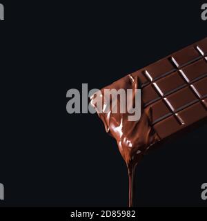 Dripping melted chocolate bar on dark background Stock Photo