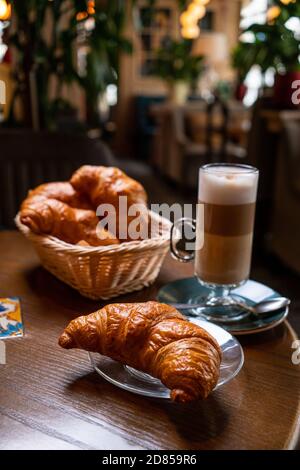 Freshly baked croissants and coffee cup on grey table. Copy space. Stock Photo