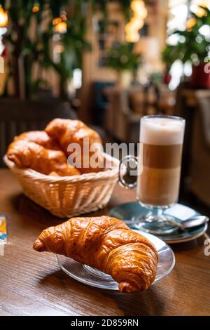 Freshly baked croissants and coffee cup on grey table. Copy space. Stock Photo