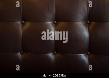 close up of black leather accent fabric of a buttoned sofa, modern style Stock Photo