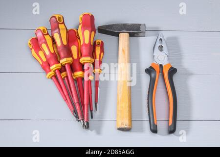 A set of a lot of different red tools for working include hammer screwdriver on gray background Stock Photo