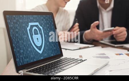 Laptop with closed padlock icon and binary code on screen Stock Photo
