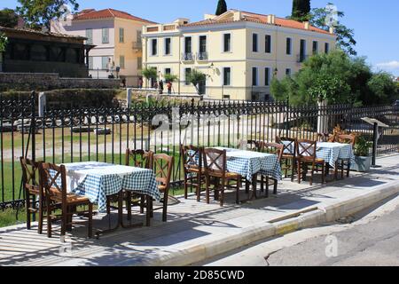 Greece, Athens, October 9 2020 - Empty chairs and tables of a traditional restaurant in the touristic district of Plaka. Stock Photo