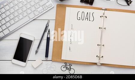 Opened Notebook With Goals List On Modern Office Desk Background Stock Photo