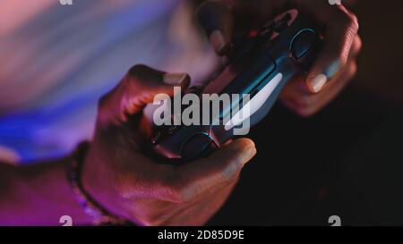 Close up, hands of black man holding video game joystick. High quality photo Stock Photo