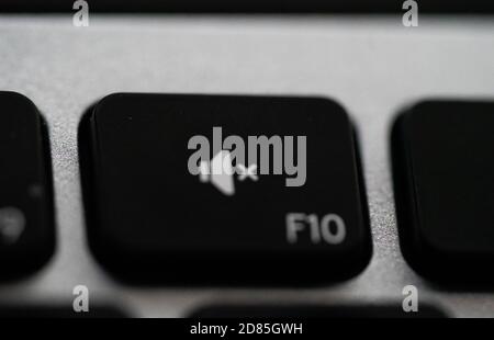 Close up of Keyboard volume mute key on space grey metal. High quality photo Stock Photo