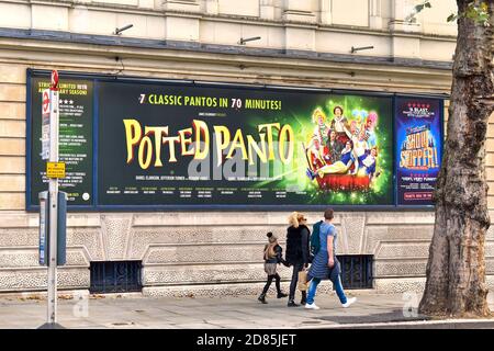 People walk past a sign advertising that Double Olivier nominees Dan and Jeff return for a social distanced festive season of Potted Panto, 7 classic pantomimes in 70 minutes at the Garrick Theatre in London. Stock Photo