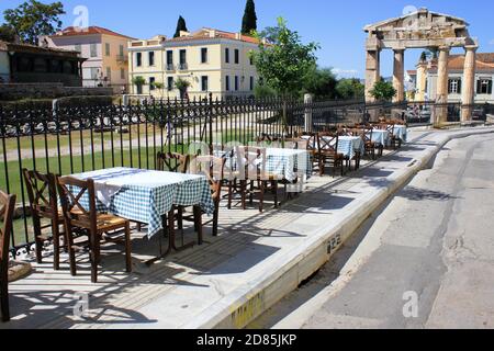 Greece, Athens, October 9 2020 - Empty chairs and tables of a traditional restaurant in the touristic district of Plaka. Stock Photo