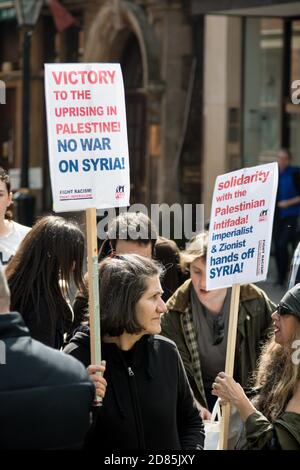 Demonstrators gather near a Palestinian flag during a protest in Lyon ...
