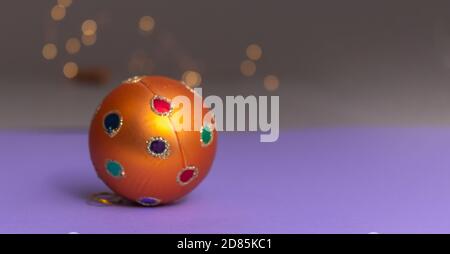 orange christmas ball foreground with light bokeh in the background and space for text. Christmas Banner Stock Photo