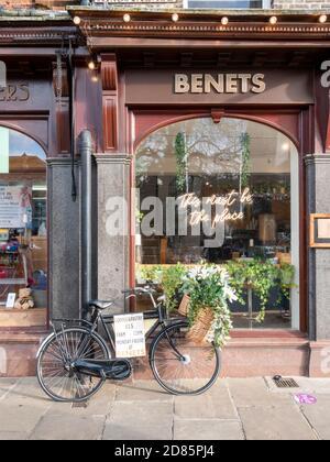 A decorated bike with basket parked outside Benets cafe and coffee shop as an advert in Kings Parade Cambridge UK Stock Photo