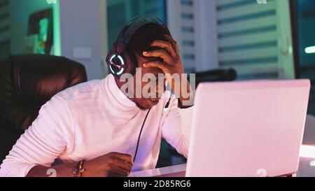 Portrait shot of disappointed young black man professional game player losing in video game. High quality photo Stock Photo
