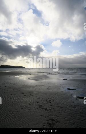 Croy Shore, Ayrshire, Scotland,UK A shaft of sunliggt breaks the clouds over the Firth of Clyde giving an almost monochromatic feel to the landscape Stock Photo