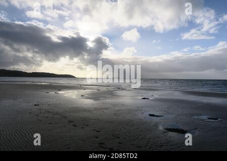 Croy Shore, Ayrshire, Scotland,UK A shaft of sunliggt breaks the clouds over the Firth of Clyde giving an almost monochromatic feel to the landscape Stock Photo