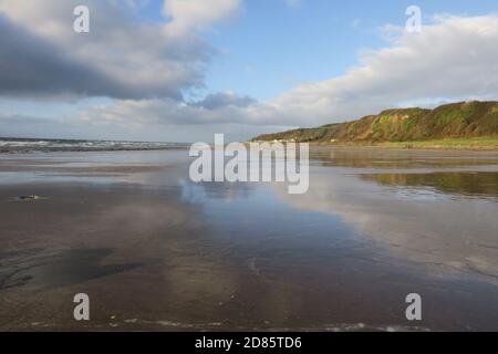 Croy Shore, Ayrshire, Scotland,UK. The sky and clouds reflectt in the still water on the wet sand giving a sense of peace and tranquility on he shoreline Stock Photo