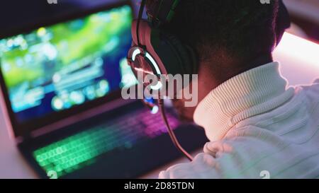Black man using laptop at night. Social media chat or overworking concept. High quality photo Stock Photo