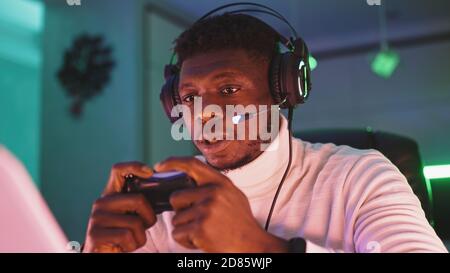 Portrait shot of focused young black man professional game player playing video games. High quality photo Stock Photo