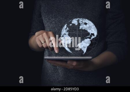 world map hologram and hand writing in laptop. Research and development software concept. Planet control Stock Photo