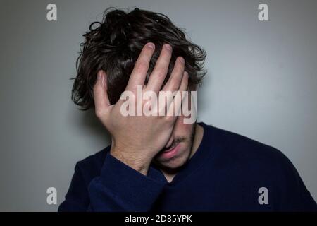 Person with Hand on Face in Disbelief Stock Photo