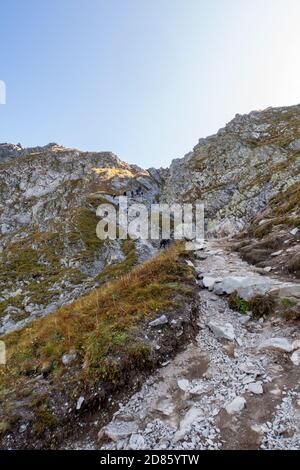 Tatra Mountains, Poland, 21/09/2020. Many tourists climbing steep trail with chains towards Szpiglasowa Pass in Tatra Mountains, Poland, autumn. Stock Photo