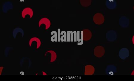 Black silhouette glimpses on blurred shimmering lights Deep bokeh backdrop Stock Photo