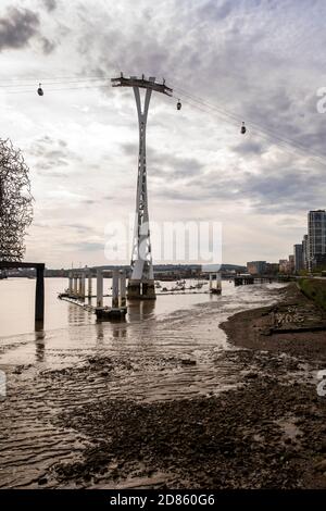 UK, London, North Greenwich, Emirates Air Line cable car service over River Thames, south bank pylon, early morning Stock Photo