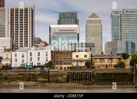 UK, London, Isle of Dogs, historic Cubitt Town riverfront properties with Canary Wharf development Stock Photo