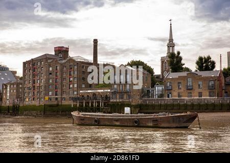 UK, London, Rotherhithe, historic Thames tunnel Mills and St Mary’s church spire beside River Thames Stock Photo