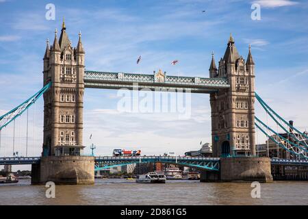 UK, London, River Thames, Thames Clipper boat passing below Tower Bridge Stock Photo