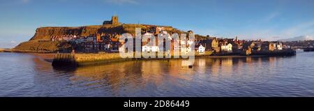Vibrant late afternoon/early evening panorama of Whitby Harbour and St Mary's Church, North Yorkshire, UK