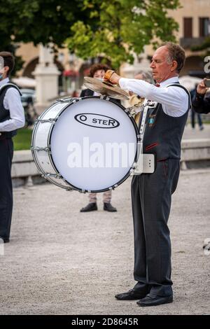 Musician of a marching band plays a bass drum and cymbals during a city festival in the center of Padua (Prato della Valle), Veneto, Italy, Europe. Stock Photo
