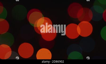 blurred dull Christmas lights light up slowly and fade out in dark deep bokeh Stock Photo