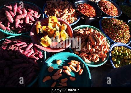 Fresh and colourful tropical vegetables and fruits in a wet market in Yala, South Thailand. Food culture concepts. Top view. Focus on pumpkin. Stock Photo