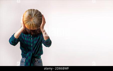 Facelaess woman is holding pumpkin. Concept photo with copy space. Stock Photo