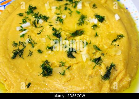 Traditional Greek Fava, yellow split pea puree with olive oil, onion and dill. Stock Photo