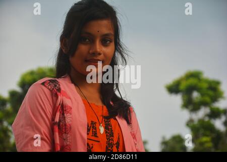 Close up of two teenage girls wearing white and pink dress with long hairs and make up posing in the open fields, selective focusing Stock Photo