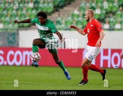 BUDAPEST, HUNGARY - SEPTEMBER 29: (l-r) Oleksandr Zubkov of Ferencvarosi TC  and Somalia of Ferencvarosi TC fights for the ball with Martin Ellingsen of  Molde FK during the UEFA Champions League Play-Offs