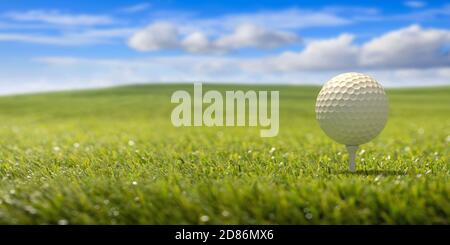 Golfball on tee ready to be shot on green lawn grass, blue sky background. Golf sport and leisure in nature, golf club course. 3d illustartion Stock Photo
