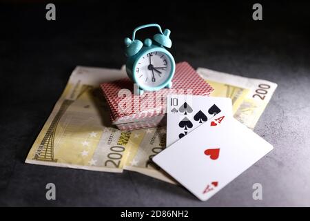 A pair of aces on a deck of playing cards with euro banknotes on a table. Online gambling. Gambling addiction Stock Photo