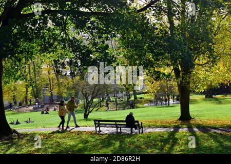 Autumn, people out for a walk, sit and relax or kids use the play area city of Bristol, Brandon Hill Park, UK Stock Photo
